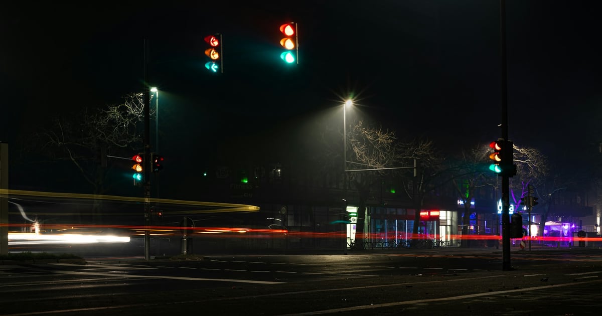 Traffic lights at an empty intersection at night